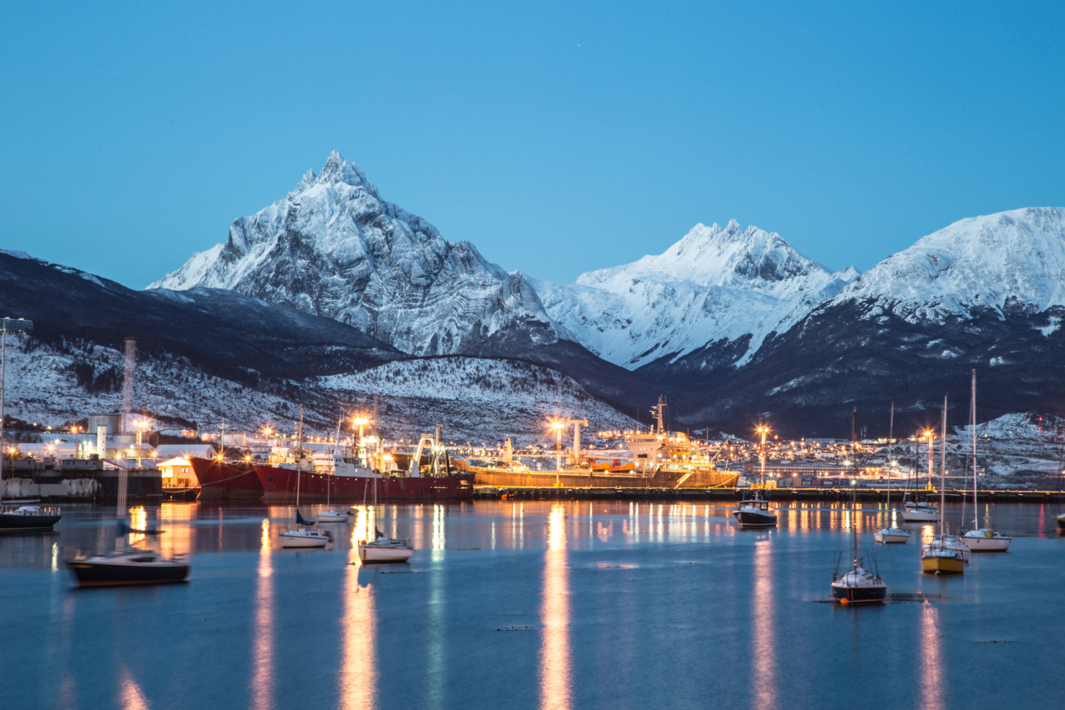 Port at dusk with snowcapped mountains
