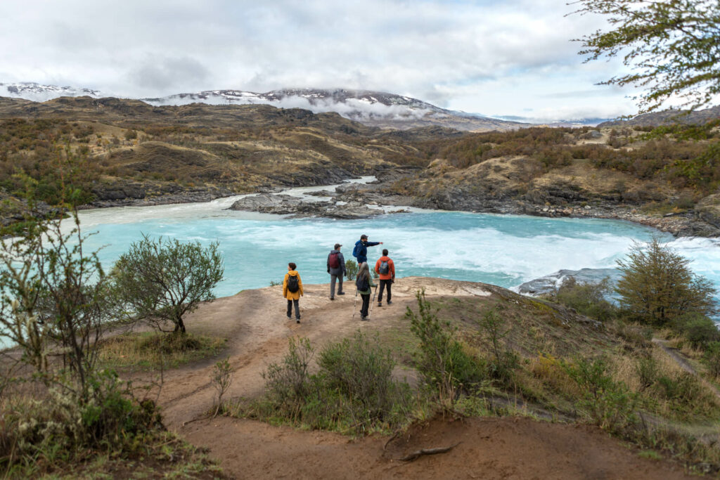 Hikers stand near a river in Patagonia National Park