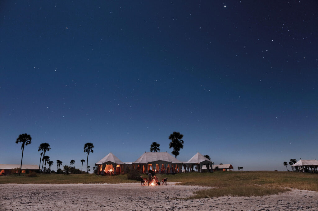 Safari tents under a starry night sky at San Camp, Kalahari