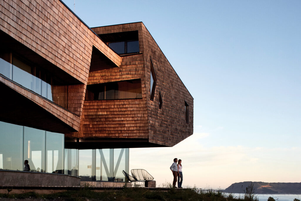 A couple stand in front of Tierra Chiloe’s stilted design