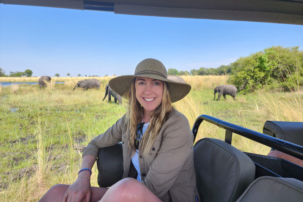 Destination specialist Abby on a game drive surrounded by elephants in the Okavango Delta.