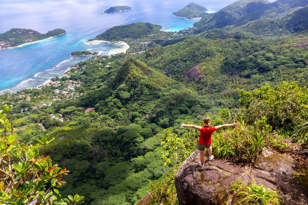 After learning how to choose the best Seychelles island, a hiker enjoys panoramic views in Morne Seychellois National Park on Mahe.