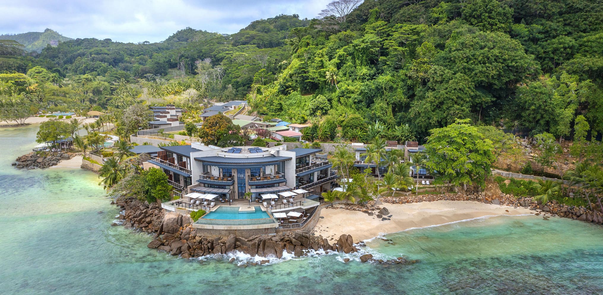 Beachfront resort nestled on a pristine Seychelles island, a top stay highlighted in our Seychelles travel guide, epitomizing luxury and natural beauty for discerning travelers.