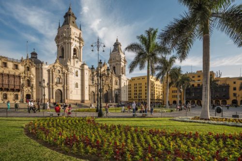 colonial cathedrals in a park with palm trees and small plantings