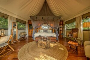 Kanana Camp interior room view of the bed and open air sides seen on our Botswana safari