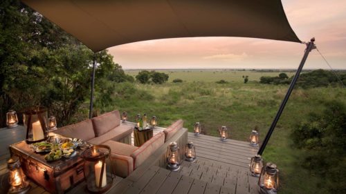 lantern lit deck with couch seating area looking out to plains