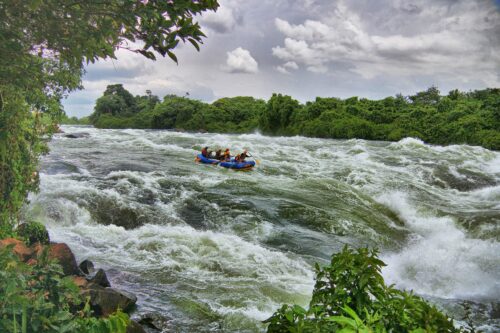 a group of people riding a raft down a river.