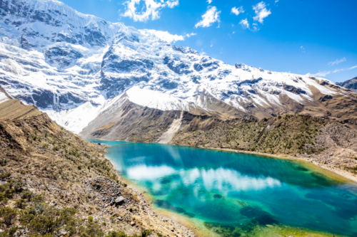 Clear blue lake in front of snowy mountain