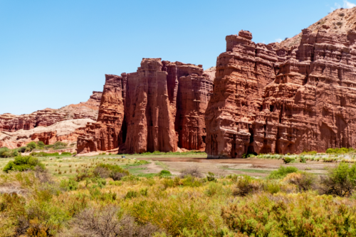 Sandstone rock formations in front of green valley