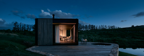 Modern cabin with deck at dusk