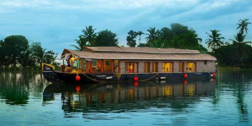 traditional houseboat floating the channels and palm trees